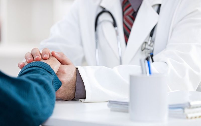 male doctor comforting patient who is in ambulance